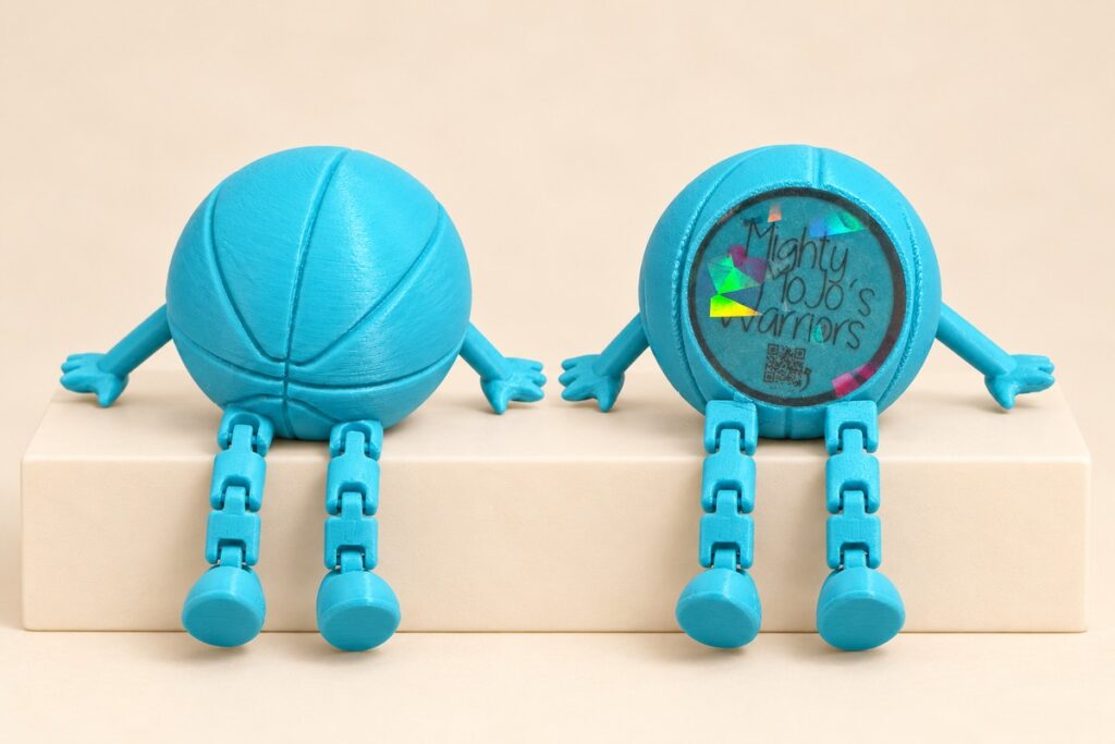Front and back views of a turquoise 3D-printed basketball figure, showing basketball grooves and the personalized inset, on an off-white background